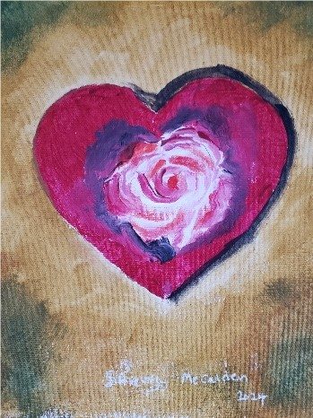 Close-up of a painted pink heart with a rose in the center