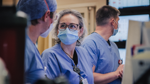 Masked caregivers in a clinical setting having a discussion