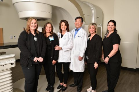 St. John Medical Team in front of True Beam Linear Accelerator | PeaceHealth St. John cuts ribbon on new True Beam Linear Accelerator continuing a legacy of quality cancer care in Cowlitz County