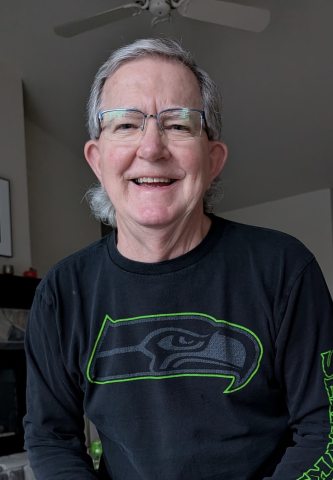 Skip Gibson smiling at the camera wearing a Seattle Seahawks shirt