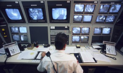 Security officer sits at desk with video monitors