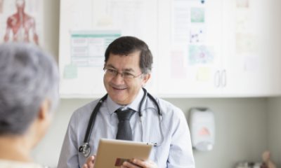 Doctor speaks in exam room with a patient