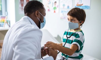 Doctor examines hand of young boy