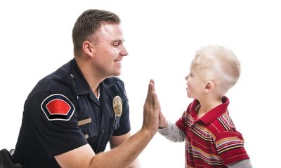Security officer high fives young boy