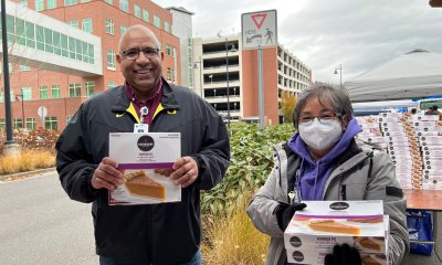 PeaceHealth caregivers hold pumpkin pies included in 800 Thanksgiving Baskets for local families in need
