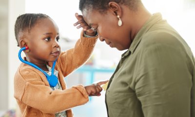 Young child touches woman's heart and head