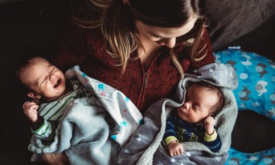 Mother holds twin babies