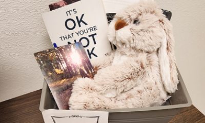 Comforting items and resources in basket for people in grief