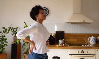 Woman holding her belly from stomach pain.