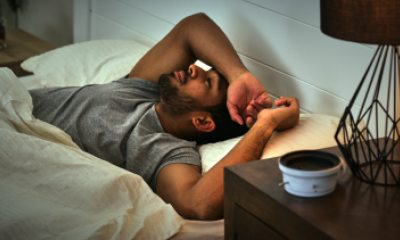 Man with a beard lying awake in bed