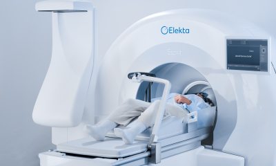 An image of a person laying down, partially inside the Gamma Knife machine, which is shaped like a circle.