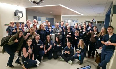 A large group of caregivers smiling at the camera in the new emergency department