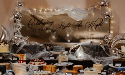 A sign that reads "Light the night" surrounded by candles and table decorations