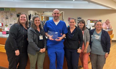 Caregivers at United General Medical Center pose with the WSHA Award at the front reception desk of the hospital