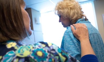 Nurse providing comfort to a female patient