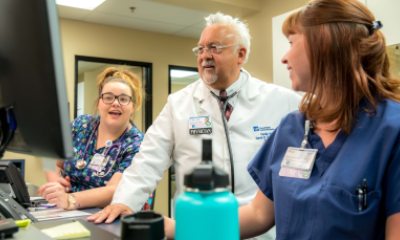 Dr. Ruiz and staff talking while looking at a computer monitor