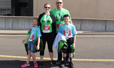 The Ellie family poses for a photo in their bibs after a marathon