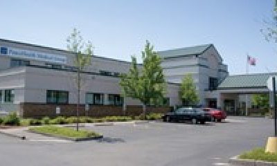 Photo of the Cordata building from the parking lot entrance