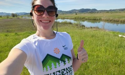 Brittany Reeves smiles and holds a thumbs up while outside for a jog
