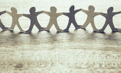 Paper cutout of people holding hands