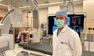 Dr. Wilder standing in an imaging lab with a mask on