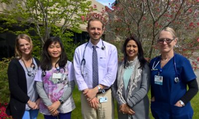 PeaceHealth staff pose for a group photo in front of trees