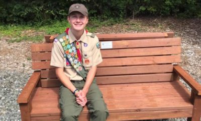 Eagle Scout sitting on a bench outside