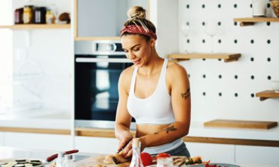 Woman fixing food at kitchen counter