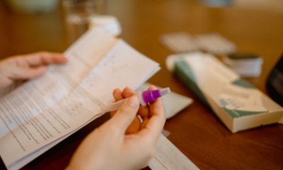 Close up of hands holding a COVID-19 at-home testing kit