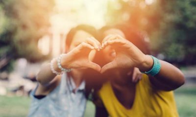 women making a heart with hands