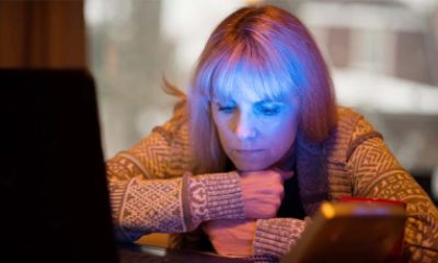 woman using SAD light and computer