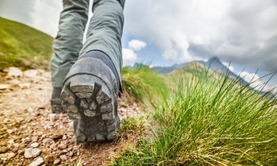 Boots hiking up a mountain trail