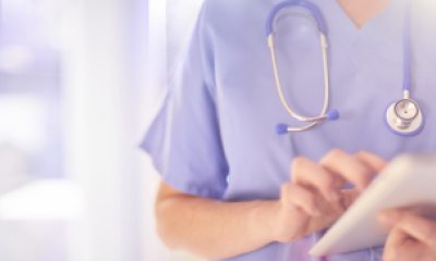 A provider holding a patient chart or ipad