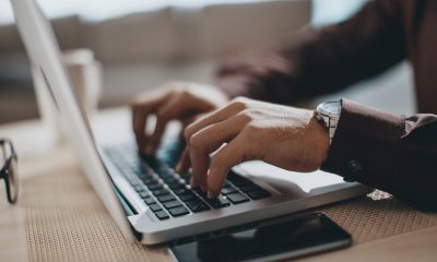 A person types on a laptop
