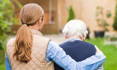 A younger woman with her arm wrapped around an older woman