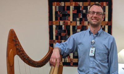 Kieran Schnabel stands near his harp
