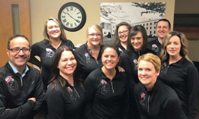 Lisa Boswell and team wear breast cancer awareness jackets