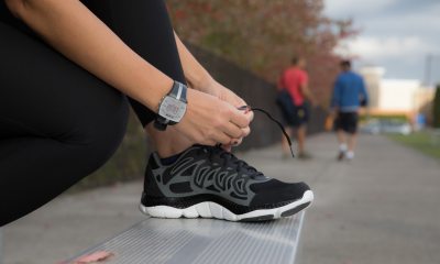 Person ties shoe in anticipation of run or walk.