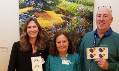 PeaceHealth pharmacy team members hold rainbow stickers 