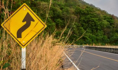 Roadside sign showing curves ahead
