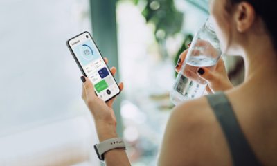 Woman checks her smartphone after exercising