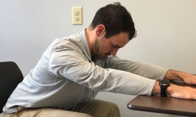 Patrick from physical therapy at PeaceHealth stretches his upper back