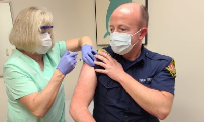 Nancy Vanderpol gives COVID-19 vaccine to Kelly Devlin