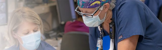 Healthcare providers review a chart in a clinical setting