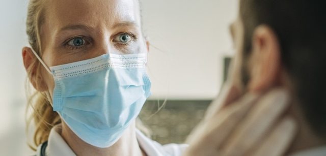 A health care provider examines a patient