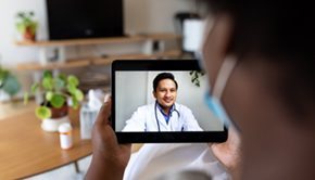 A provider speaks to a patient through a mobile device
