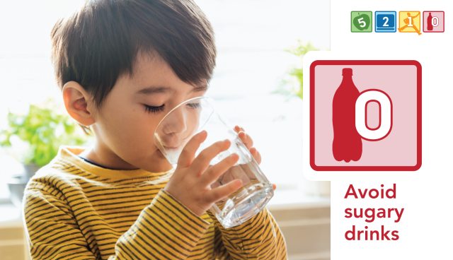 Young child drinking a glass of water