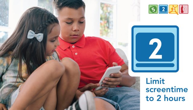 Two children look at the screen of a mobile phone