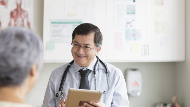 Doctor speaks in exam room with a patient