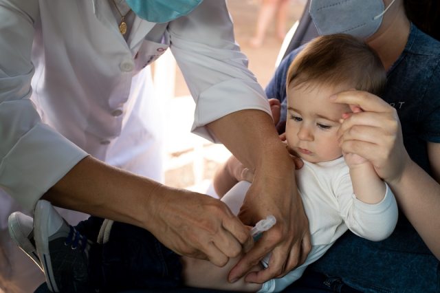 A child receives a vaccination from a healthcare provider